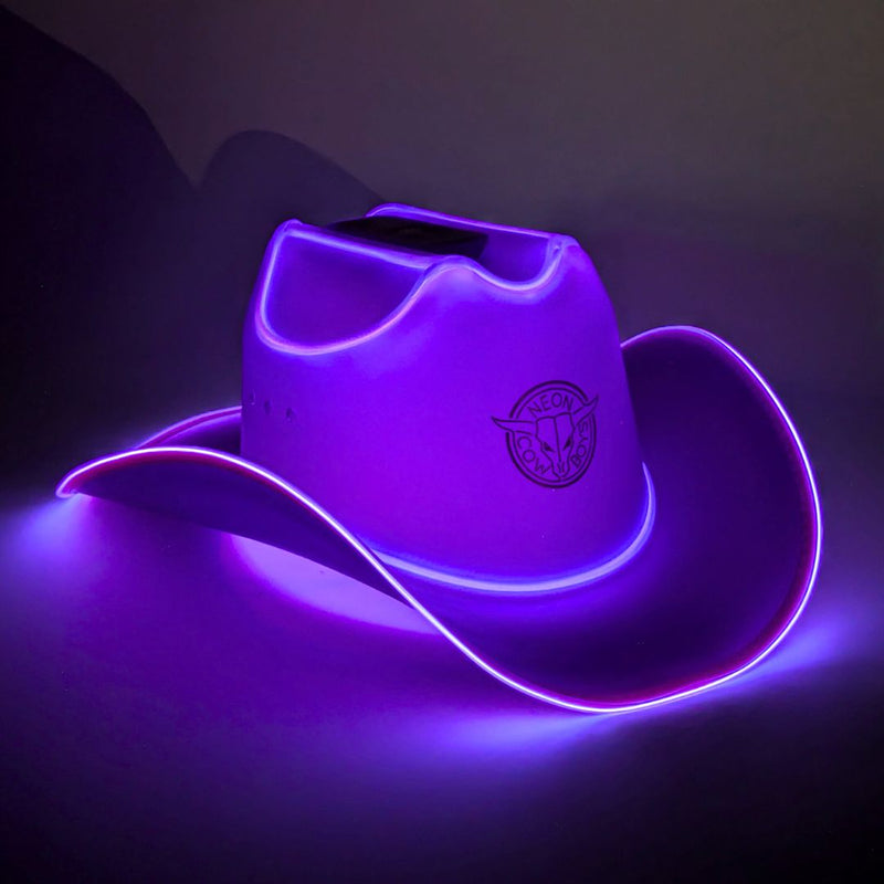Purple glowing LED light-up cowboy hat with a lit brim in a dark studio, a purple cowboy hat with bright LED lights glowing perfect for Mardi Gras krewe celebrations and western themed party planning, a neon glow cowboy hat for raves, country concerts and bachelorette parties, Neon Cowboys