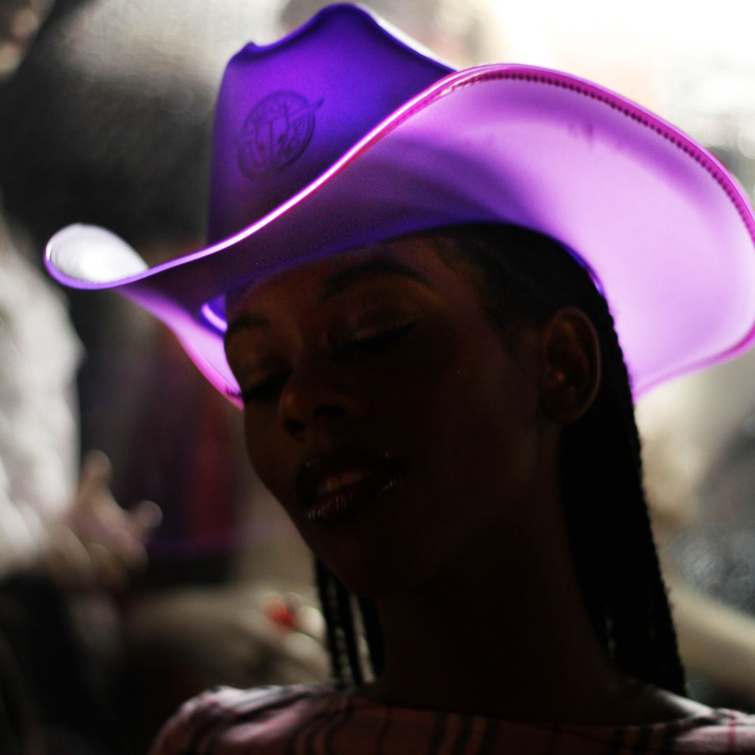 Purple space cowgirl hat glowing bright for Coachella music festival outfits western rave costumes and electronic dance fashion