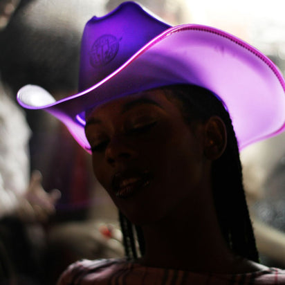Purple space cowgirl hat glowing bright for Coachella music festival outfits western rave costumes and electronic dance fashion