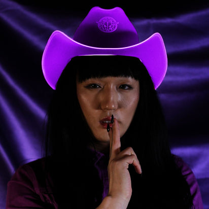 Purple space cowgirl hat with LED lights glowing for royal themed parties princess celebrations and western costume luxury events