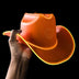 Orange sustainable plastic LED cowboy hat held in hand - Color-transition illuminated western headwear in vibrant colors for summer festivals, beach parties, country bars, and western fashion statements
