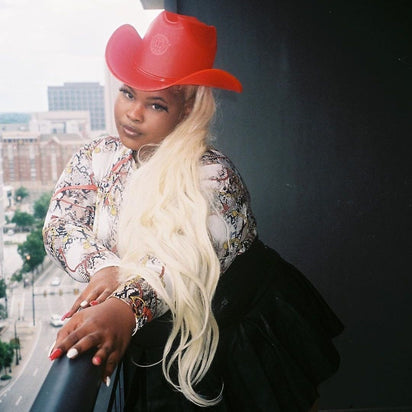 Red neon cowgirl hat glowing with LED lights for Christmas holiday party celebrations and western costume festive outfits