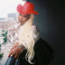 Red neon cowgirl hat glowing with LED lights for Christmas holiday party celebrations and western costume festive outfits