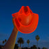 Red cowboy hat with bright lights glowing perfect for nightclub parties dance events and western costume festival fashion