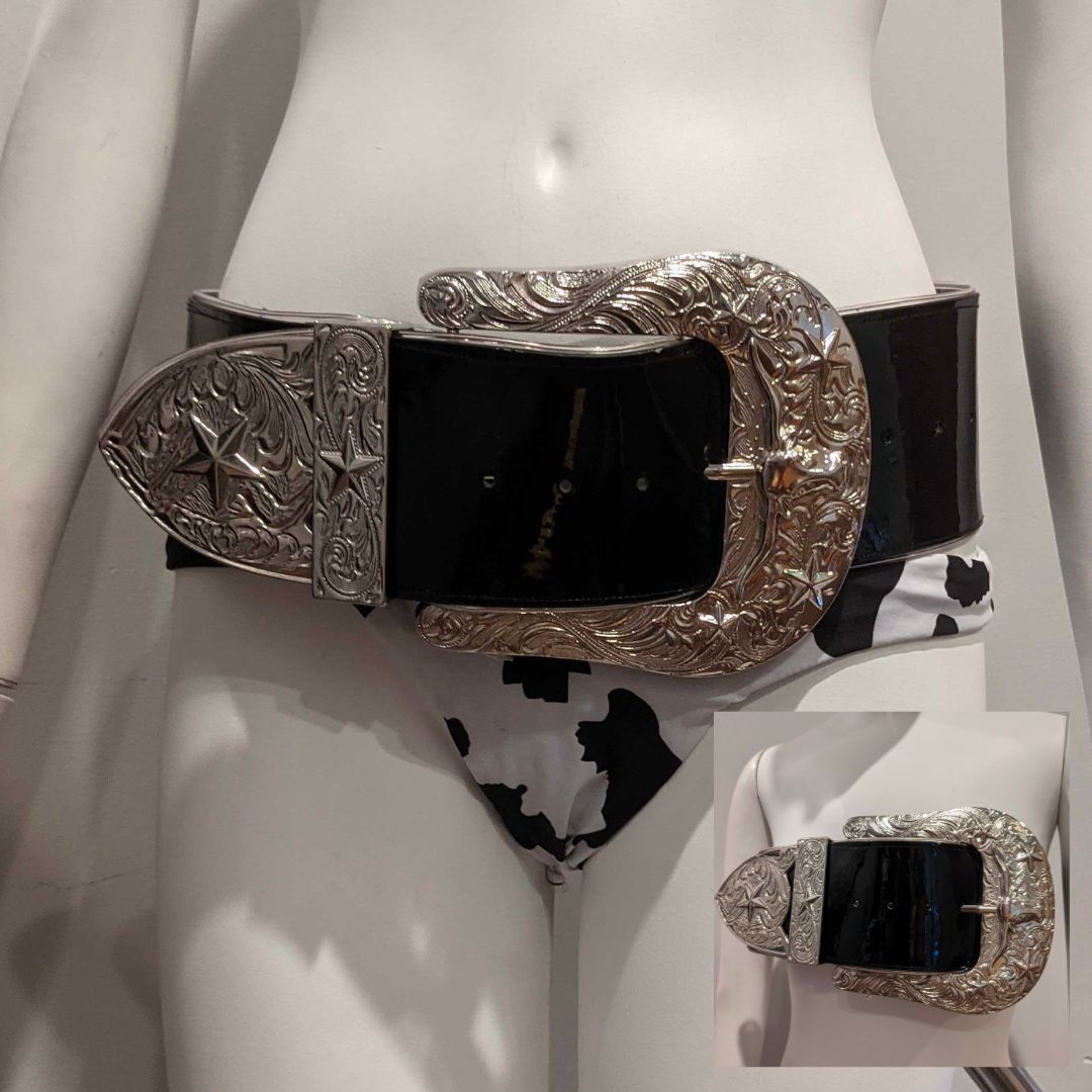 Close-up of silver western belt with large ornate buckle and matching accessory displayed on female form perfect for western-inspired outfits country concerts and cowgirl fashion statements