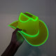 Hand holding green LED cowboy hat in dark setting - Side view of acid green illuminated western hat showing glowing trim
