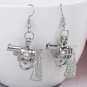 Silver Pistol Earrings in Daylight - Glowing View of Gun Shaped Jewelry - Lightweight Metal Statement Earrings for Everyday Edgy Style