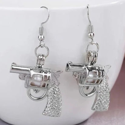 Silver Pistol Earrings in Daylight - Glowing View of Gun Shaped Jewelry - Lightweight Metal Statement Earrings for Everyday Edgy Style