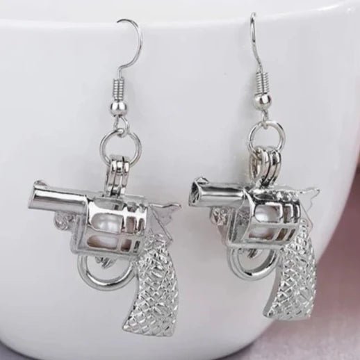 Silver Pistol Earrings in Daylight - Glowing View of Gun Shaped Jewelry - Lightweight Metal Statement Earrings for Everyday Edgy Style