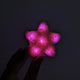 Pink LED star fuzzy hair clip held in hand - Vibrant illuminated star-shaped hair accessory for princess parties, Valentine's Day events, sweet sixteen celebrations, and girl gang outfits