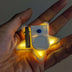 Hand showing battery compartment of LED star fuzzy hair clip - Technical detail of illuminated star-shaped hair accessory demonstrating easy battery access for long-lasting use at concerts and all-night events