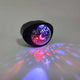 Close-up of individual star projector light attachment showing multi-color LED pattern capability and compact size for roller skate customization