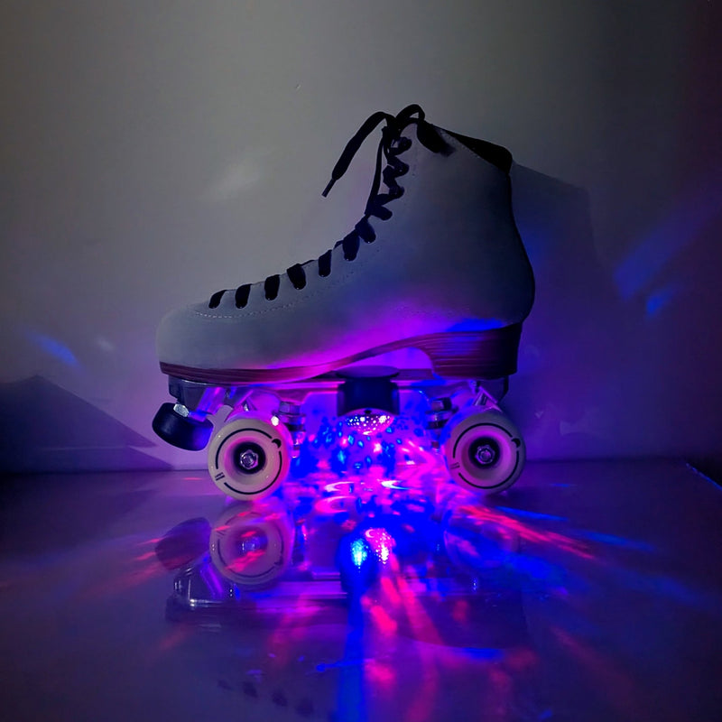White roller skate with an LED star projector casting pink and blue light on the floor, light up star projector skate lights creating vibrant star patterns perfect for roller disco parties, night skating, skating rink events and glow parties, Neon Cowboys