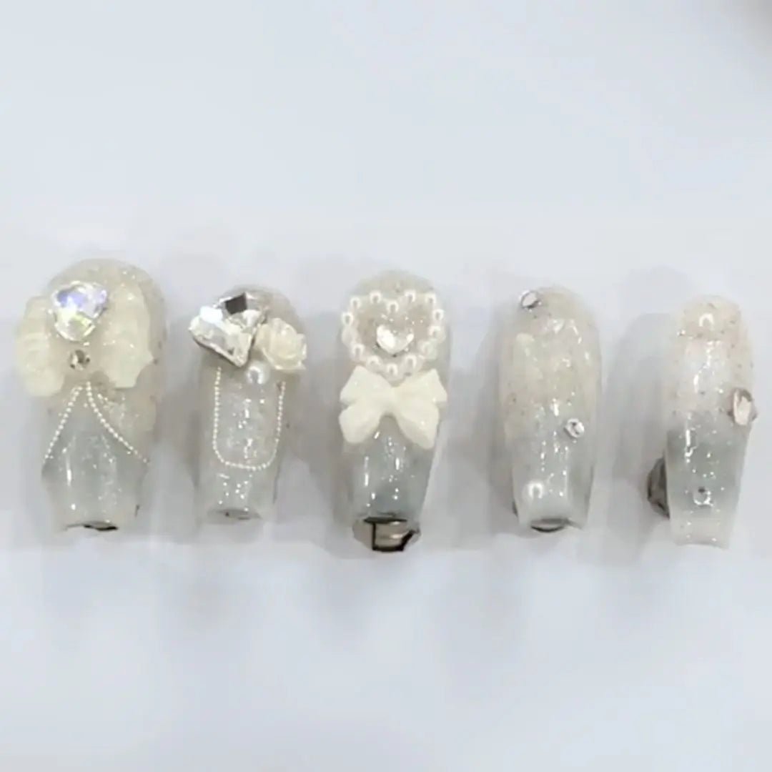 Set of light up LED nails that press on for weddings, receptions, birthdays, events, and parties that have rhinestone pearls bows and fancy detailing