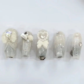 Set of light up LED nails that press on for weddings, receptions, birthdays, events, and parties that have rhinestone pearls bows and fancy detailing