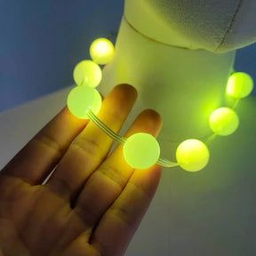 Yellow LED Sphere Necklace in Hand - Glowing Ball Beads for Raves - EDM Festival Party Favor for Group Events and Concerts - Light up Halloween Costume Jewelry