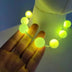Yellow LED Sphere Necklace in Hand - Glowing Ball Beads for Raves - EDM Festival Party Favor for Group Events and Concerts - Light up Halloween Costume Jewelry