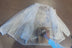 Folded clear animated horse jacket showing transparent design with embedded light up technology for male festival fashion and space cowboy costumes
