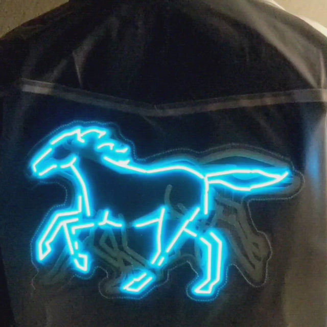 video of animated neon blue horse design running across back of jacket showing movement patterns for futuristic cyberpunk music festival outfits