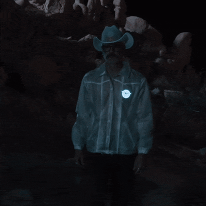 Close-up of glowing blue animated horse illuminating on men's jacket perfect for motorcycle night riding and futuristic space cowboy festival outfits