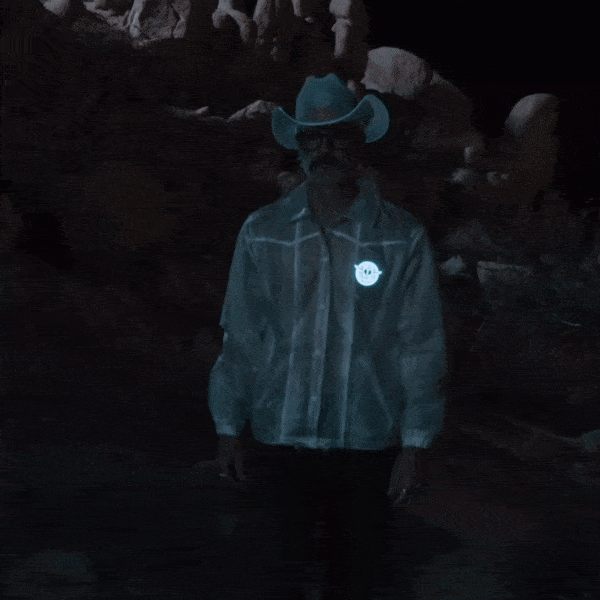 Close-up of glowing blue animated horse illuminating on men's jacket perfect for motorcycle night riding and futuristic space cowboy festival outfits