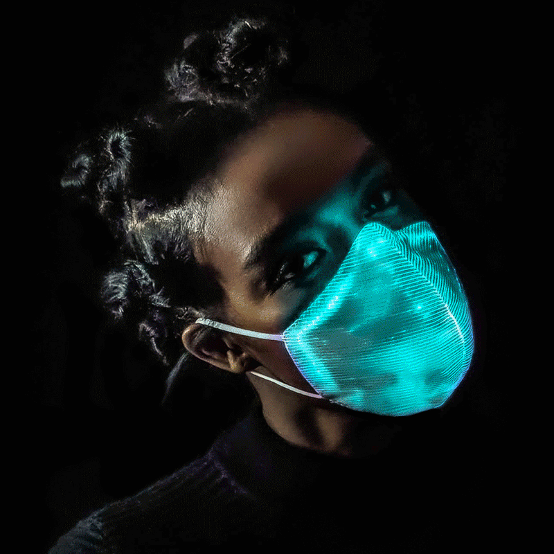 Woman wearing a teal glowing LED light up glow mask against a dark background, color changing led glow mask and light up facemask for raves, music festivals, EDM concerts, Halloween costumes, and cosplay, Neon Cowboys