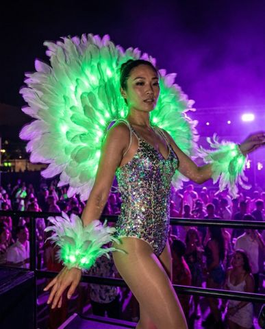 Performer in a glowing LED feather costume &mdash; Neon Cowboys stage & event performer outfits